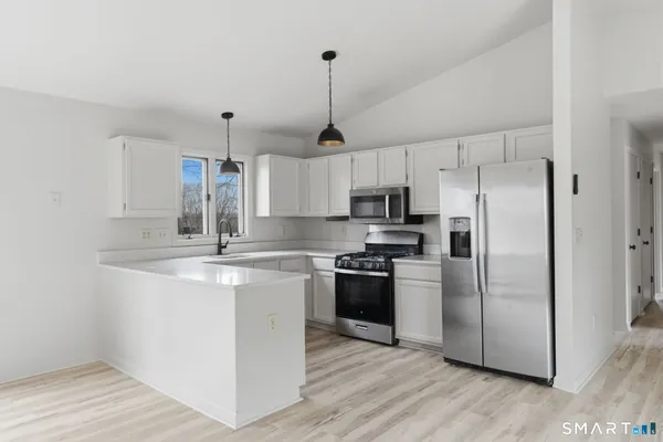 a kitchen with a refrigerator a sink and a stove