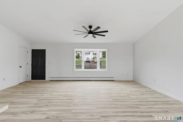 wooden floor in an empty room with a window