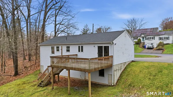 a view of a house with backyard and sitting area
