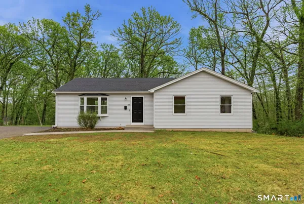 a view of a house with a yard