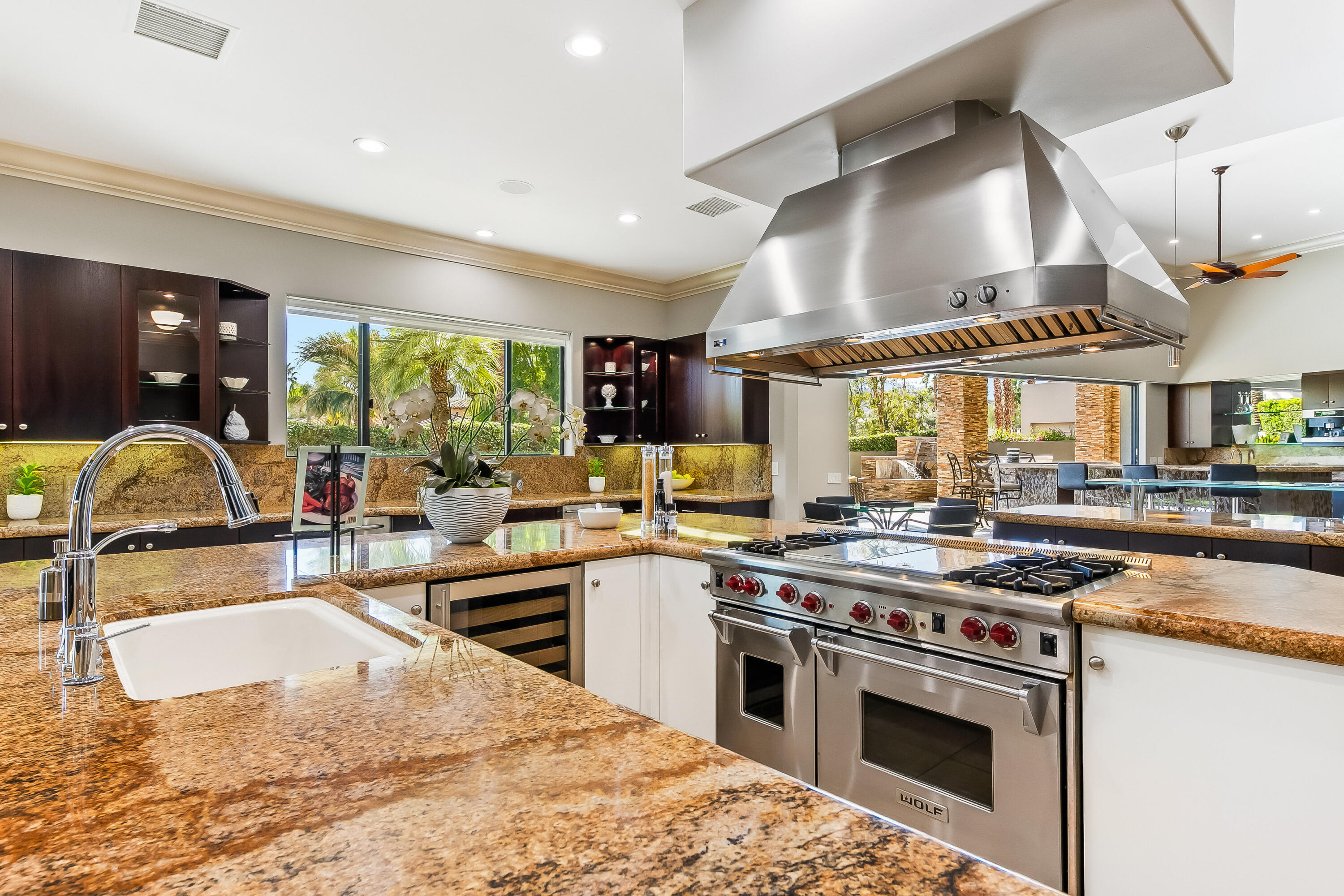 15 Sun Ridge Circle Rancho Mirage, CA 92270 - Photo 13 of 53 a kitchen with stainless steel appliances granite countertop a stove a sink and a microwave
