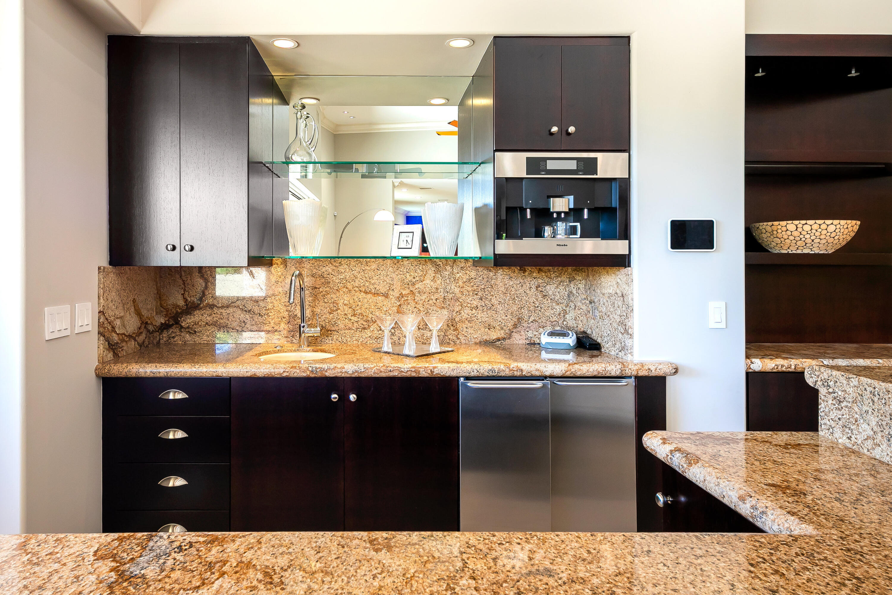 15 Sun Ridge Circle Rancho Mirage, CA 92270 - Photo 22 of 53 a kitchen with stainless steel appliances kitchen island granite countertop a sink and cabinets