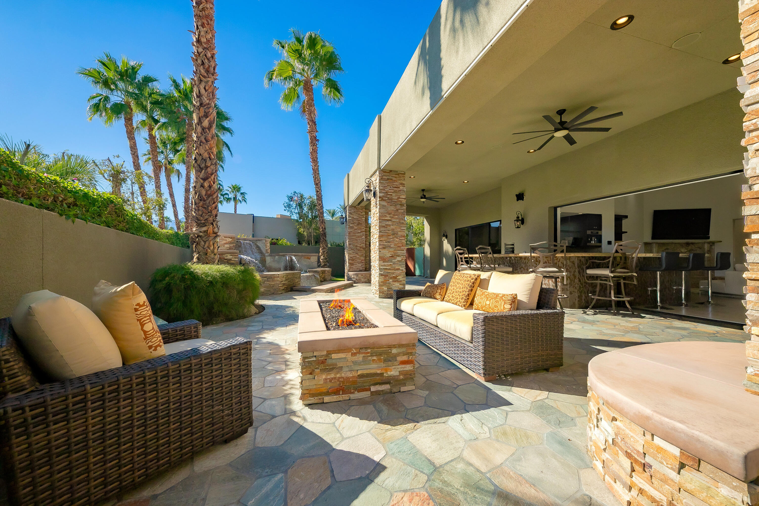 15 Sun Ridge Circle Rancho Mirage, CA 92270 - Photo 24 of 53 a view of a patio with couches dining table and chairs with potted plants