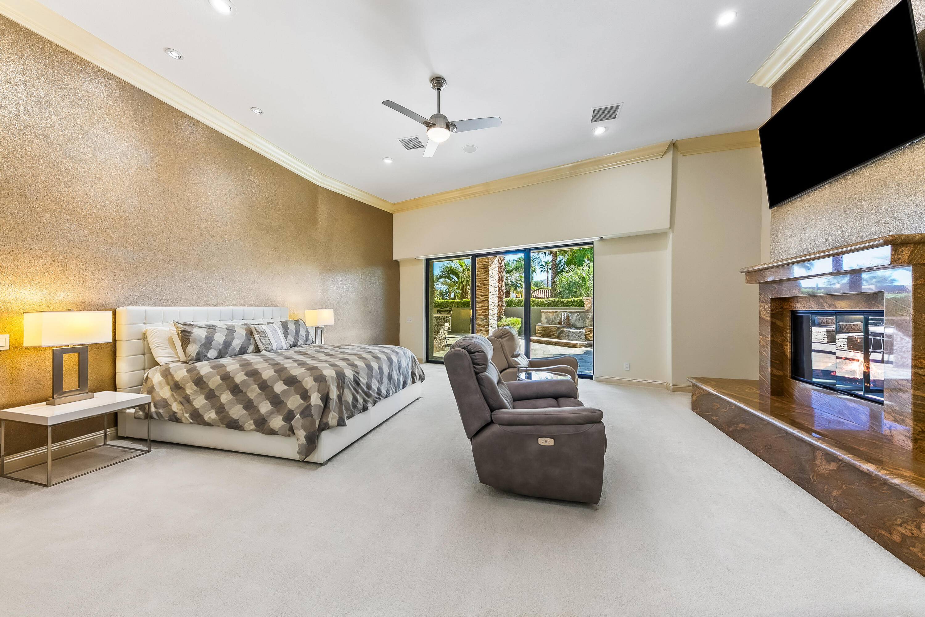 15 Sun Ridge Circle Rancho Mirage, CA 92270 - Photo 29 of 53 a spacious bedroom with a bed and glass door