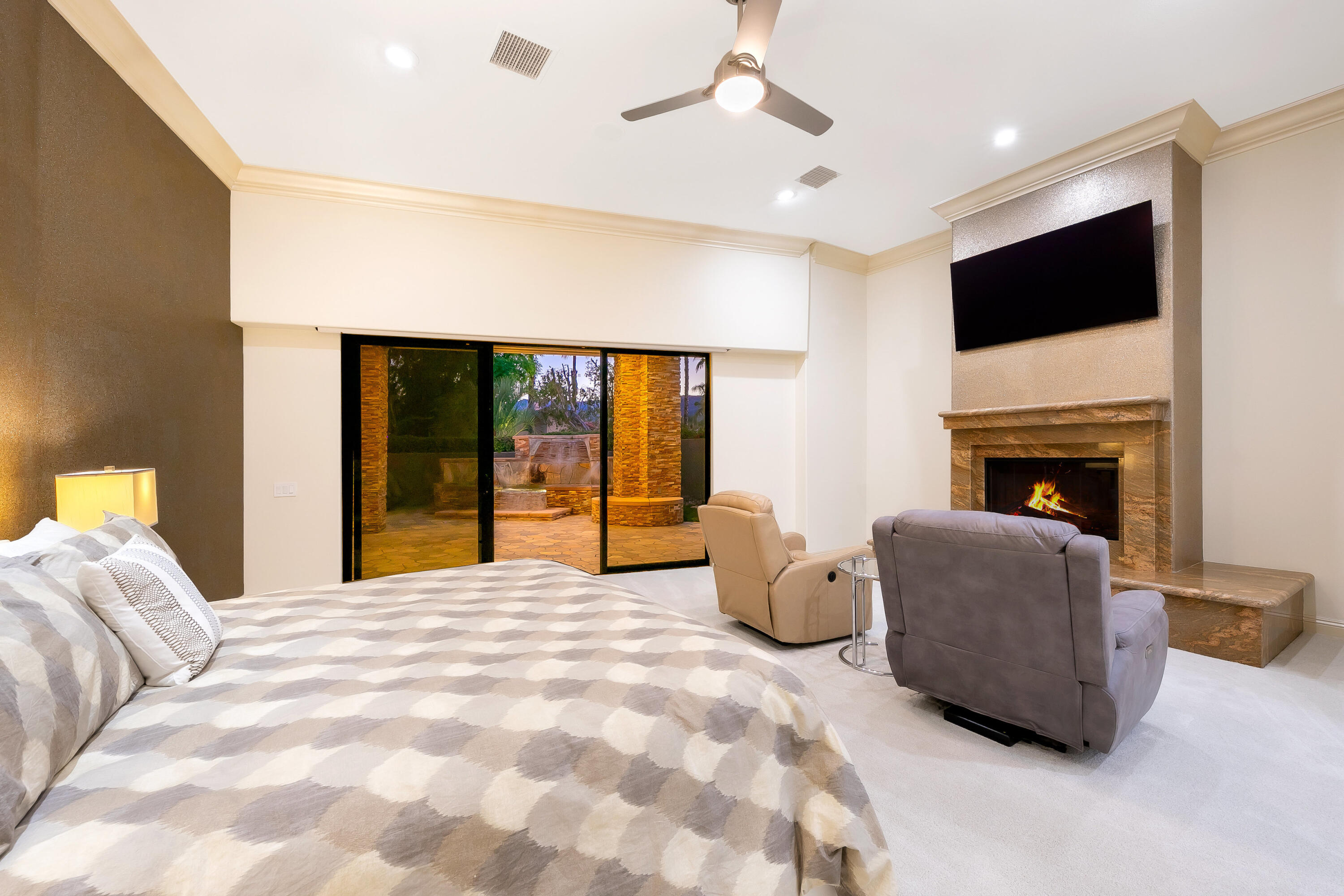 15 Sun Ridge Circle Rancho Mirage, CA 92270 - Photo 30 of 53 a large bed sitting in a spacious bedroom next to a window with a flat screen tv