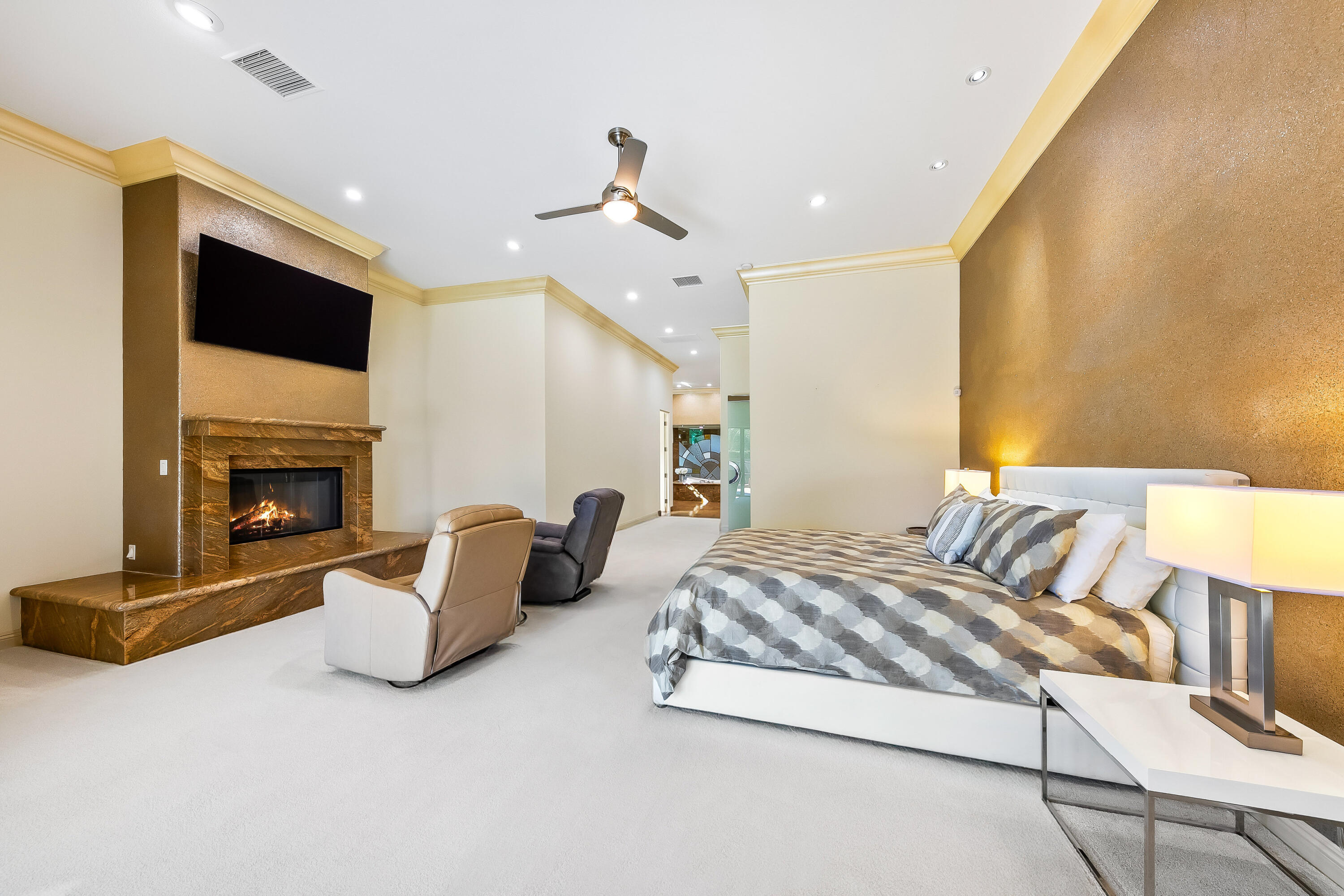 15 Sun Ridge Circle Rancho Mirage, CA 92270 - Photo 31 of 53 a spacious bedroom with a bed and a fireplace