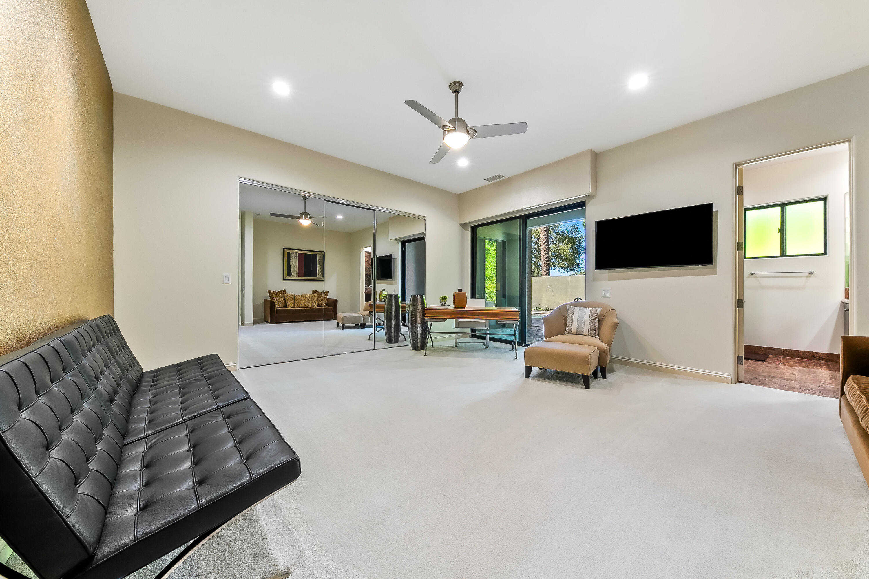15 Sun Ridge Circle Rancho Mirage, CA 92270 - Photo 36 of 53 a living room with furniture and a flat screen tv