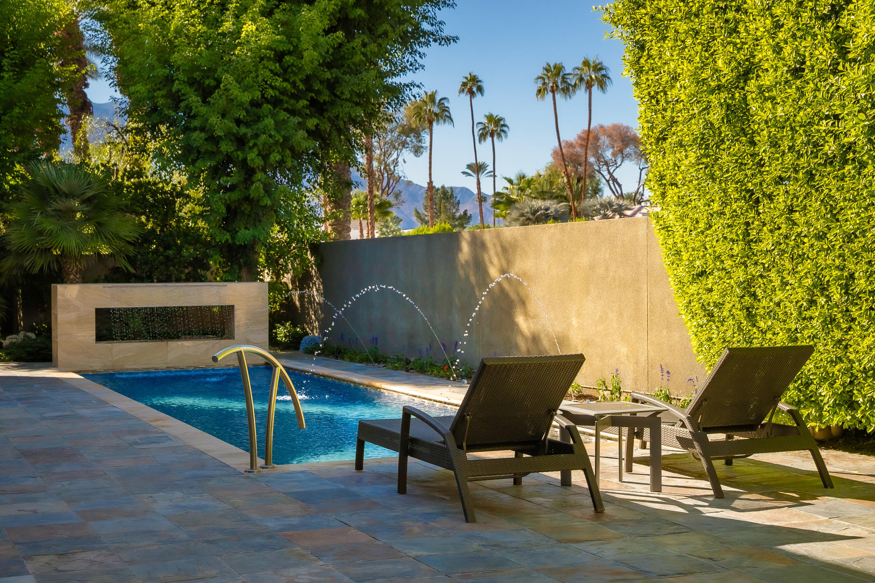 15 Sun Ridge Circle Rancho Mirage, CA 92270 - Photo 44 of 53 a view of a chairs and table in a backyard