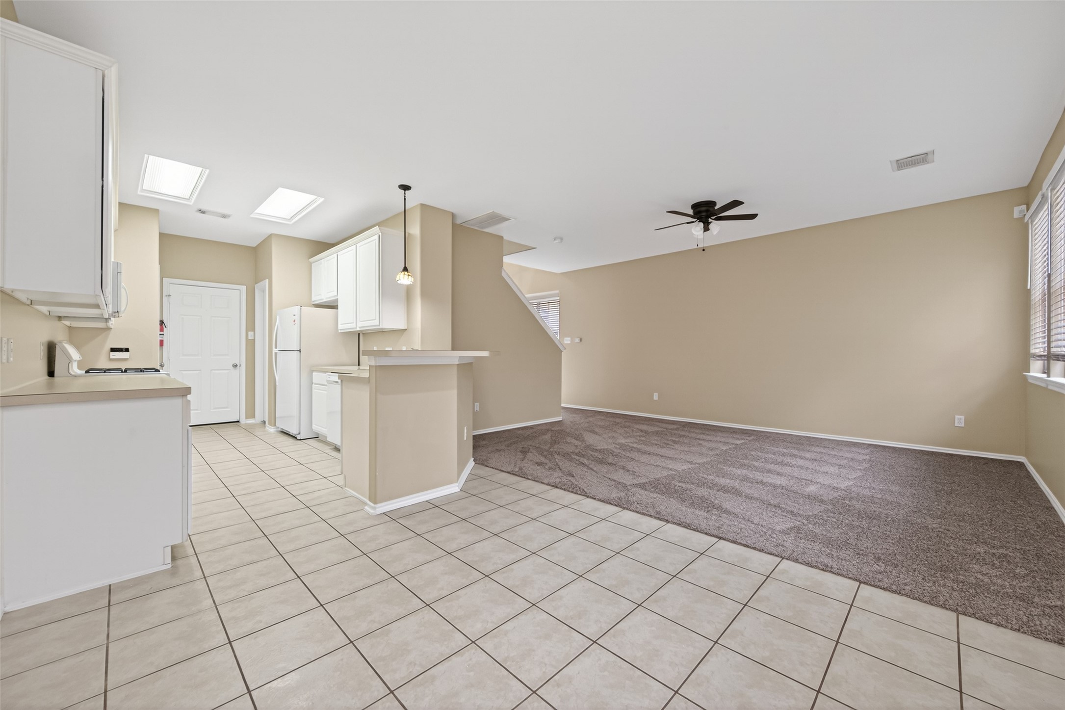169 Musewood Court Spring, TX 77382 - Photo 12 of 44 a view of kitchen with white cabinets and wooden floor