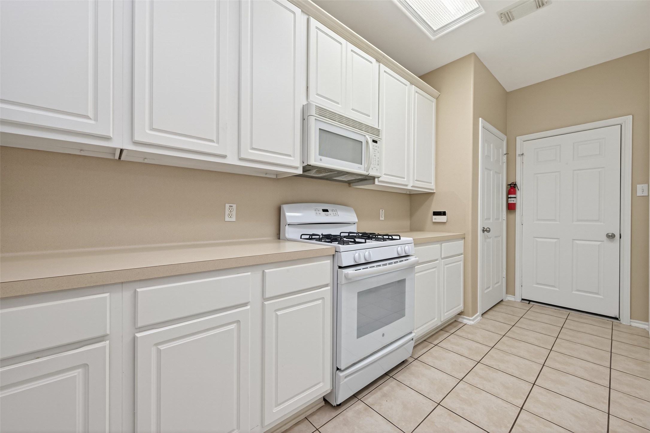 169 Musewood Court Spring, TX 77382 - Photo 14 of 44 a kitchen with stainless steel appliances granite countertop a sink and a stove