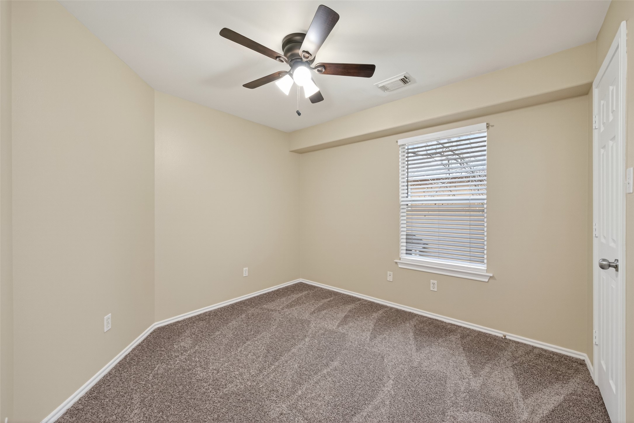 169 Musewood Court Spring, TX 77382 - Photo 25 of 44 an empty room with a window and a ceiling fan