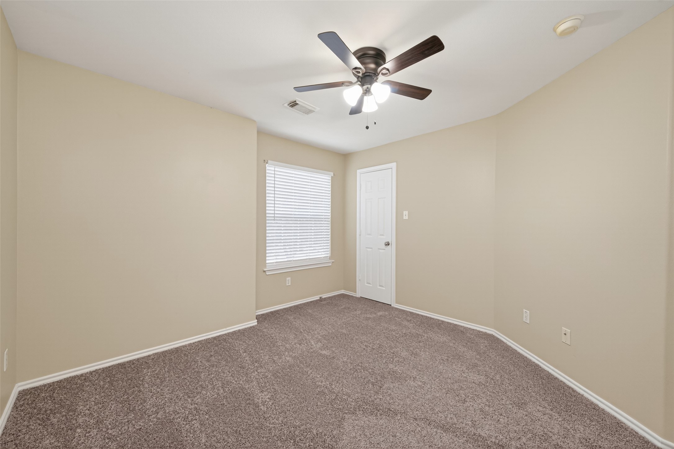 169 Musewood Court Spring, TX 77382 - Photo 27 of 44 an empty room with windows and fan
