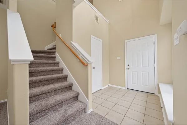 a view of a big room with a ceiling fan and carpet