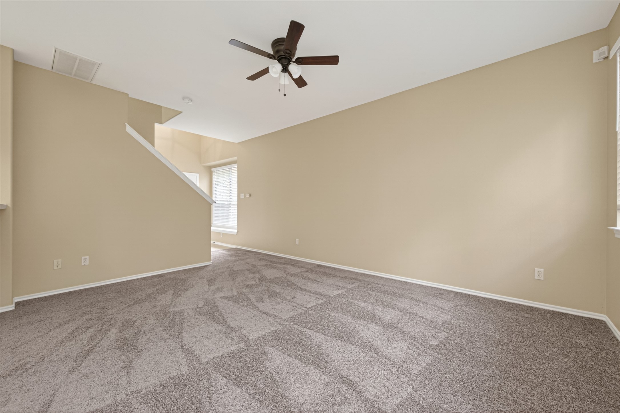 169 Musewood Court Spring, TX 77382 - Photo 8 of 44 a view of a big room with a ceiling fan and carpet