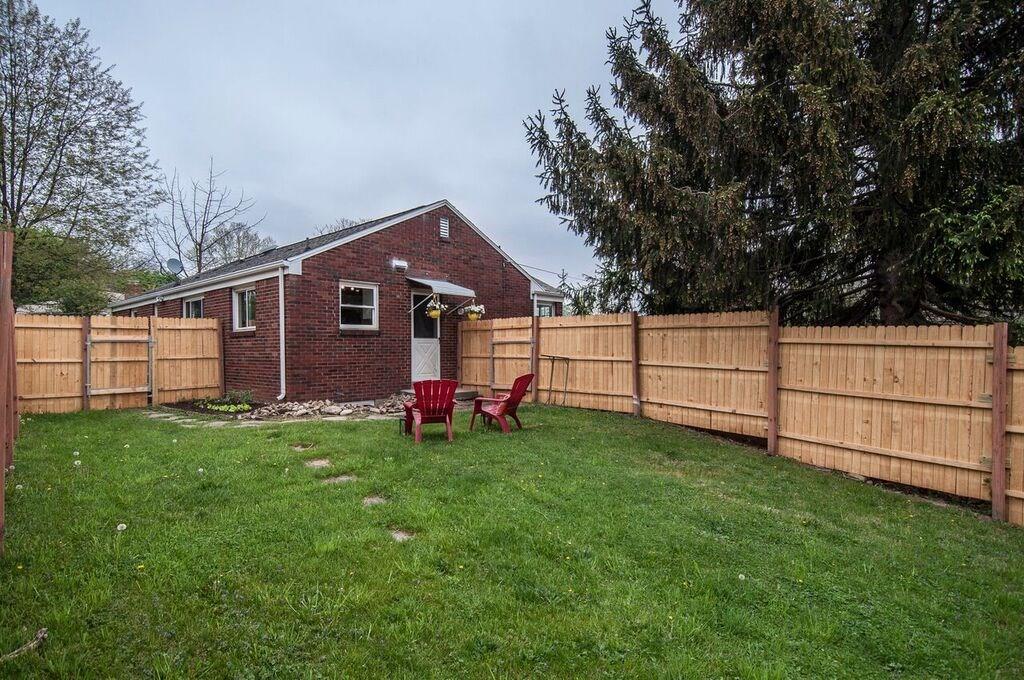 1327 Freeport Road Pittsburgh, PA 15238 - Photo 23 of 25 A new fence encloses the large grassy yard. Note the herb garden under the kitchen window.