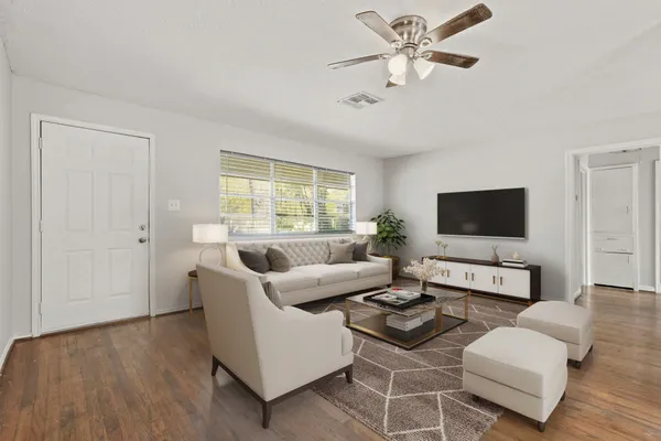 a living room with furniture and a flat screen tv