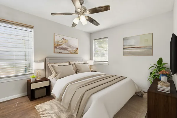 a bedroom with bed painting on the wall and a window