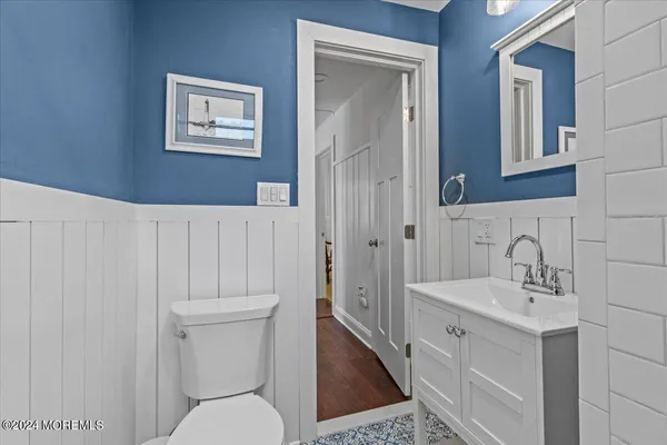 a bathroom with a toilet a sink and mirror