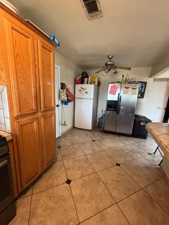 a bedroom with a bed and a ceiling fan