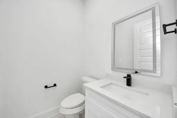 a bathroom with a sink a toilet and a mirror
