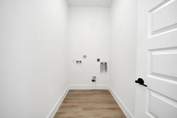 a view of a hallway with wooden floor and a ceiling fan