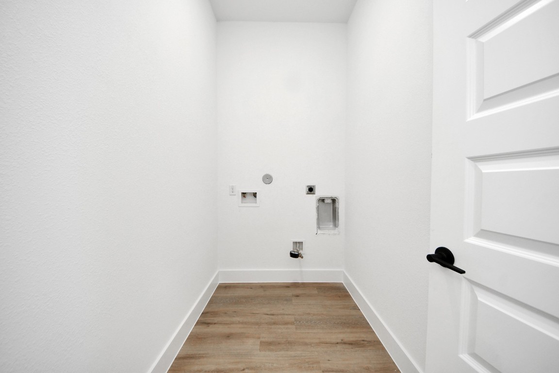 3310 Hardy Street Houston, TX 77009 - Photo 12 of 26 a view of a hallway with wooden floor and a ceiling fan