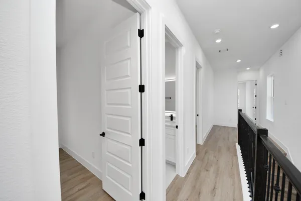 a view of hallway with wooden floor