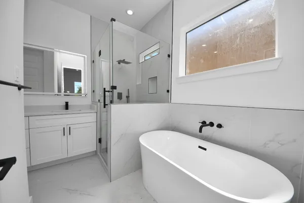 a white bath tub sitting next to a white sink