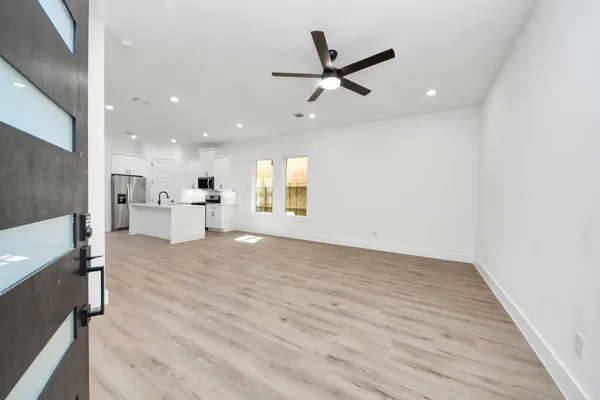 a view of a kitchen with a sink and a refrigerator