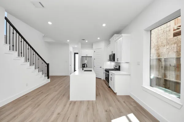a view of kitchen with furniture and wooden floor