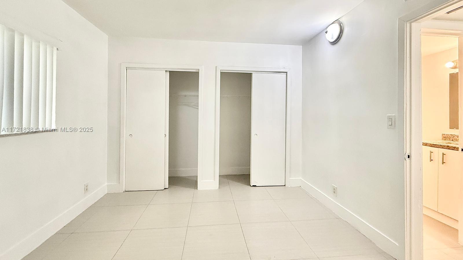 42 Southwest 14th Street, Unit 103 Dania Beach, FL 33004 - Photo 18 of 18 a view of an empty room with window and bathroom