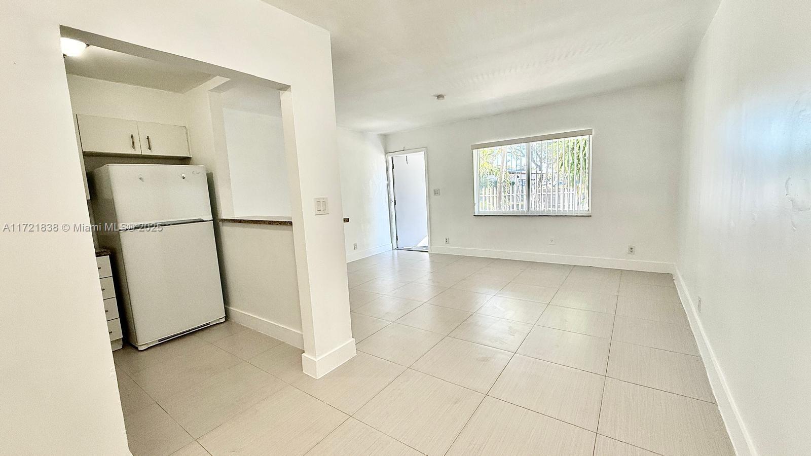 42 Southwest 14th Street, Unit 103 Dania Beach, FL 33004 - Photo 7 of 18 a view of a kitchen with a refrigerator