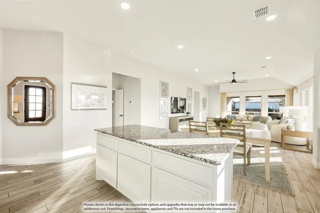 a living room with fireplace furniture and a table