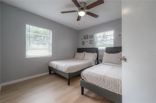a bedroom with two beds and a window