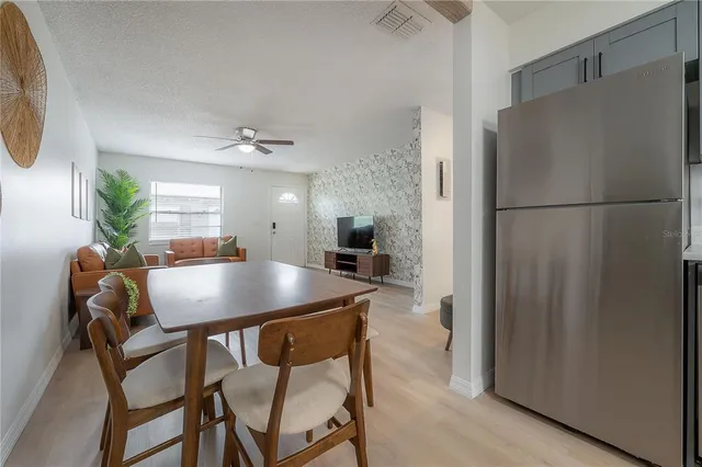 a view of a dining room with furniture and a chandelier