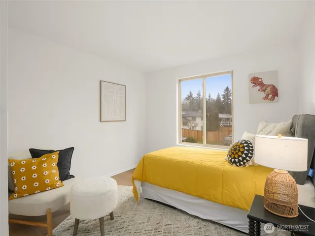 a bedroom with a bed and chair