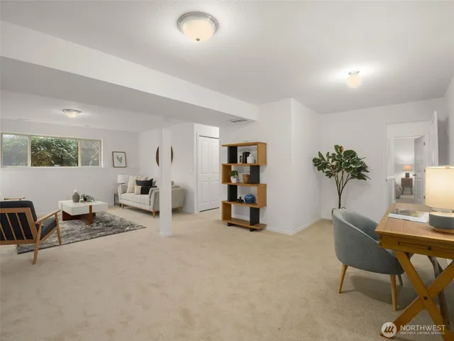 a living room with furniture and a potted plant
