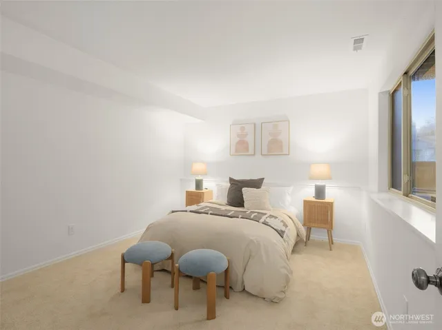 a bedroom with a bed and a large mirror