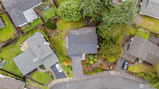 an aerial view of a house with a garden and swimming pool