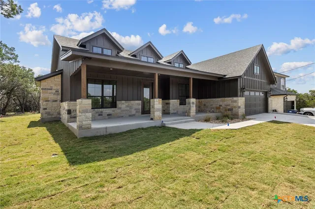 a front view of the house with swimming pool and furniture