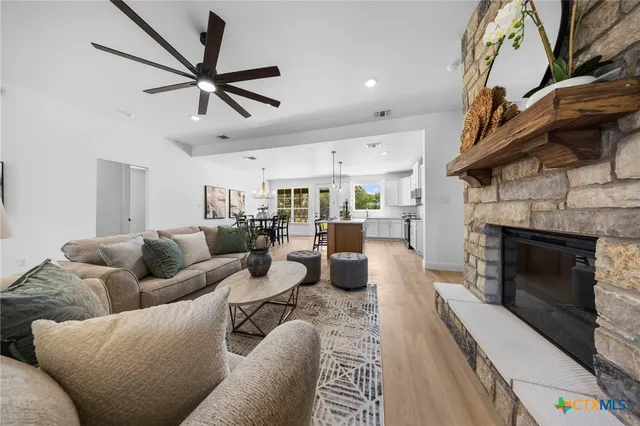 a living room with furniture fireplace and a window