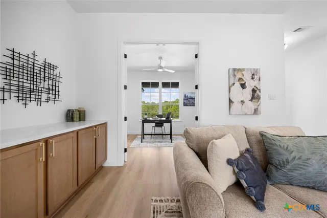 a living room with furniture and a wooden floor