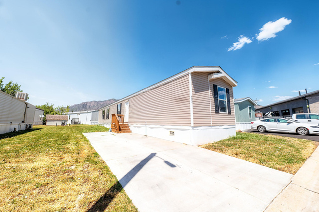 2491 Highway 89, Unit 403 Pleasant View, UT 84404 - Photo 1 of 32 Light tan horizontal siding exterior with white trim and dark window shutters