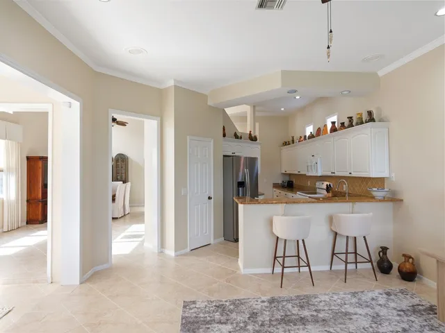 a kitchen with stainless steel appliances granite countertop a sink and a refrigerator