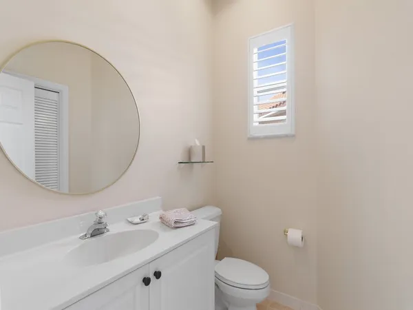 a bedroom with a bed a dresser next to a window