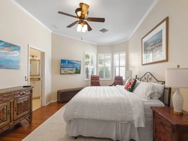 a bedroom with a large bed and a chandelier