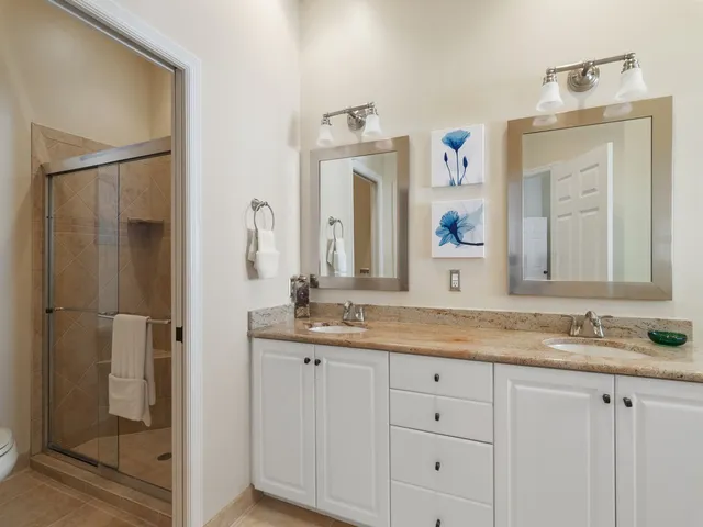 a bathroom with a granite countertop sink mirror and bathtub