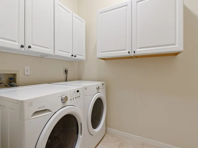 a bedroom with two beds and a large window