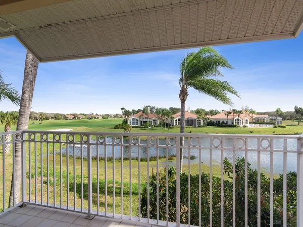 a view of a lake with a big yard and potted plants