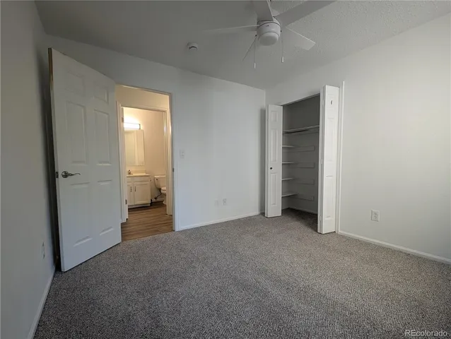 an empty room with closet and a bathroom
